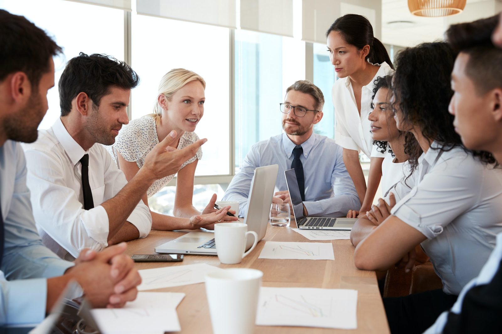 Training participants in discussion at a meeting table
